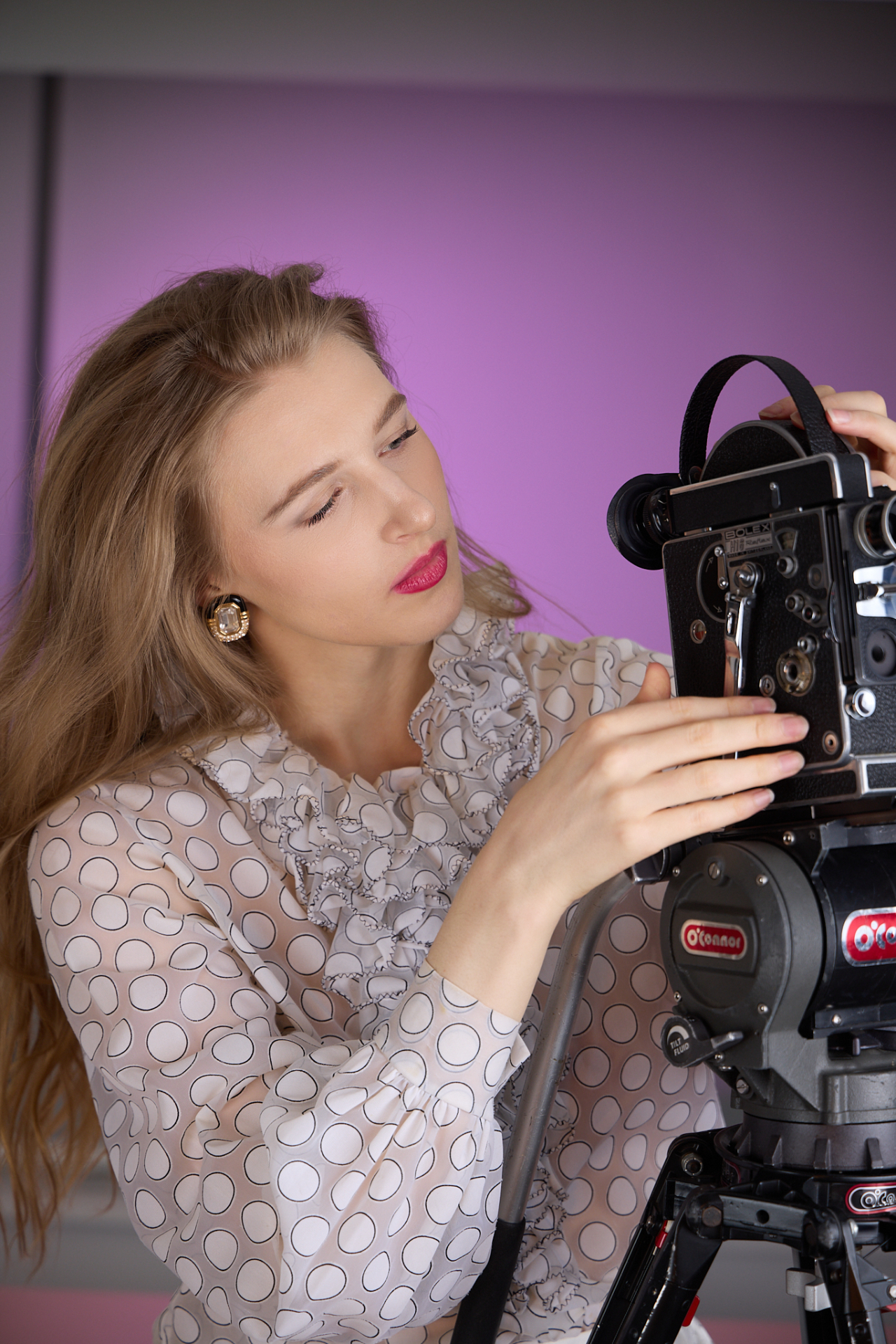 Dreamlet filmmaker adjusting a vintage 16mm camera.